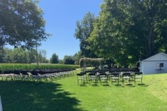 Chairs setup in front of barn for ceremony