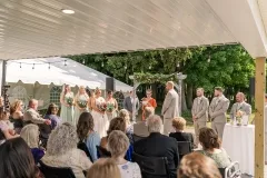 Barn Patio during ceremony, bride, groom & wedding party
