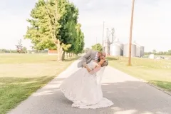 Bride and Groom Kiss on the Road